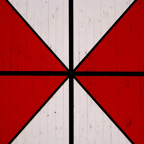 Abstract design depicting red and white triangles arranged in a square